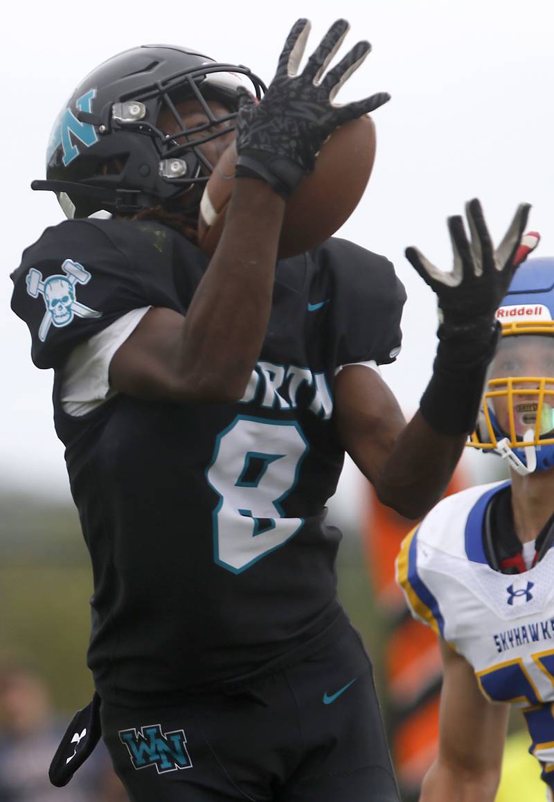 Woodstock North's Maxwell Dennison catches the ball in front of Johnsburg's Duke Mays during a Kishwaukee River Conference football game Saturday, Aug. 26, 2023, at Woodstock North High School.