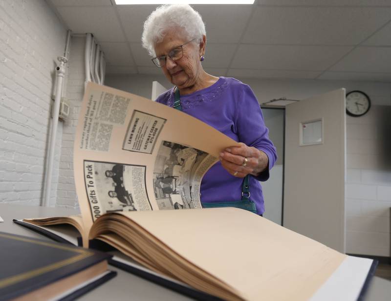 Juanita Roberts-Beams of Tiskilwa, pages through a memorabilia book  of Gateway Services on Wednesday, Aug. 27, 2025 in Princeton. The non-profit organization celebrates it's 55th anniversary this year.