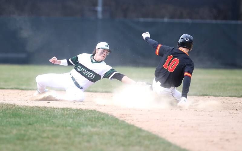 Glenbard West’s Jacob Aseltine (left) reaches for the tag as Batavia’s Nate Nazos is safe at second during a game at Village Green Park in Glen Ellyn on Wednesday, March 13, 2024.