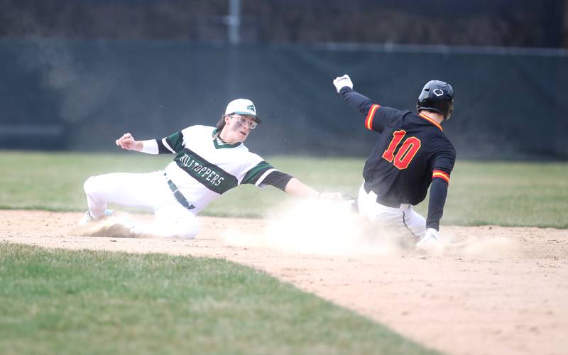 Glenbard West’s Jacob Aseltine (left) reaches for the tag as Batavia’s Nate Nazos is safe at second during a game at Village Green Park in Glen Ellyn on Wednesday, March 13, 2024.