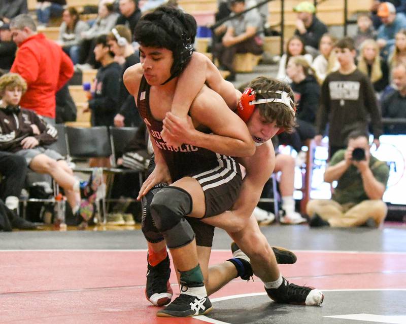 Ramsey Barton of Yorkville, right, tries to control Jon Higueros of Joliet Catholic Academy during the 106-weight class during the regional meet on Tuesday Feb. 25, 2025, held at Yorkville High School.