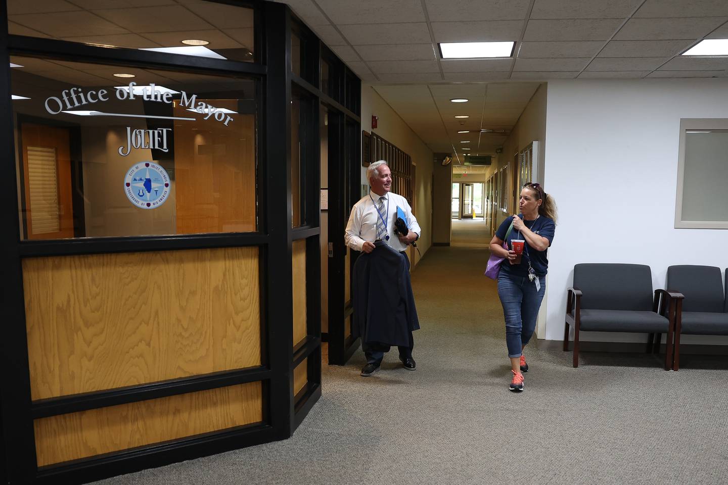 Mayor Terry D’Arcy talks with a city worker as he arrives at his office in City Hall on Friday, Aug. 11, 2023 in Joliet.