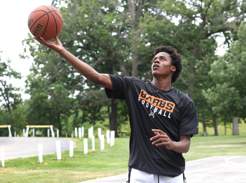 LeBron Carrington, 15, from DeKalb, plays basketball during the Juneteenth Community Celebration Saturday, June 15, 2024, at Hopkins Park in DeKalb.
