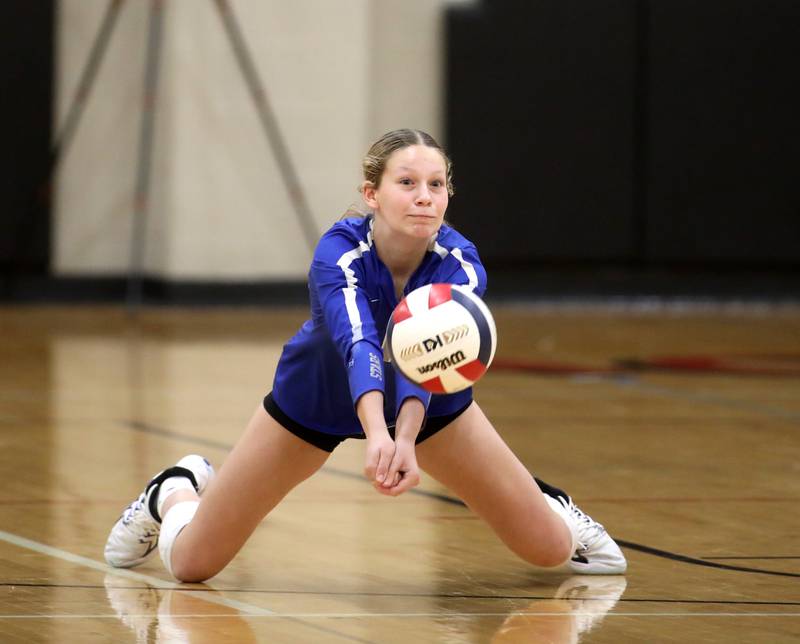 St. Charles North’s Erin Skidmore digs for the ball during a game on Monday, Oct. 7, 2024 at Benet in Lisle.
