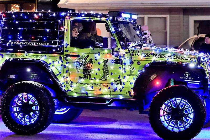 Chris Sperry lit up the night Saturday with the QC Freedom Crawlers in the annual Christmas Parade in Erie on Saturday, Dec. 7, 2025.