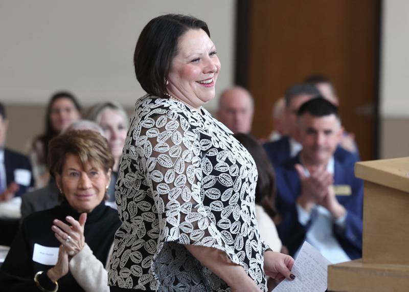 Nicole Patterson comes up to receive the Chamber Champion Award Thursday, March 5, 2026, during the Sycamore Chamber of Commerce Annual Meeting in Memorial Hall at St. Mary's Catholic Church in Sycamore.