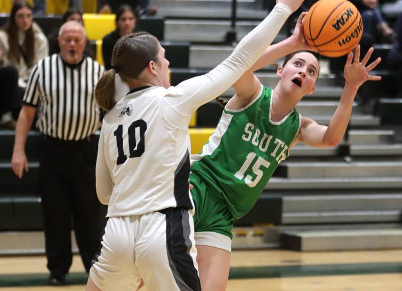 Crystal Lake South’s Tessa Melhuish, right, shoots as Kalie Brown of Kaneland defends in IHSA Class 3A Regional Title Game girls basketball action on Friday, Feb. 21, 2025, at Crystal Lake South High School in Crystal Lake.