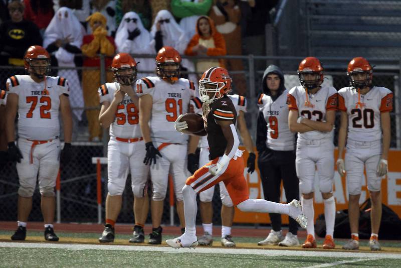 Hersey's Nasir Mckenzie (2) heads in for a long touch down against Wheaton Warrenville South during the IHSA Class 7A playoffs Saturday October 28, 2023 in Arlington Heights.