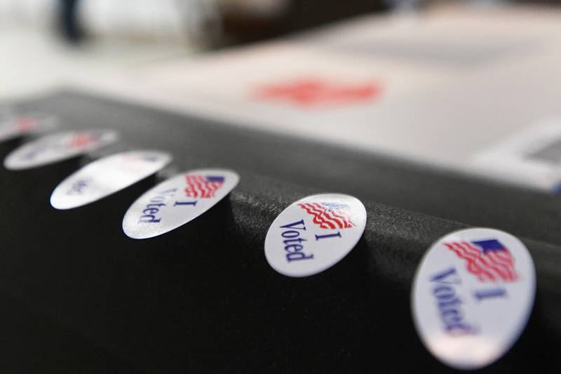 Stickers line the scanner as voters cast their ballots on an Election Day.