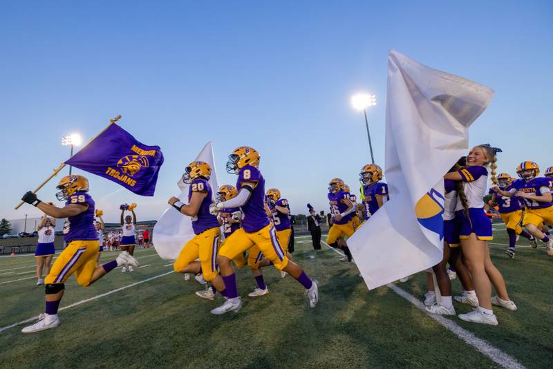 The Mendota Trojan's varsity team runs onto the field prior to the start of the game against Hall at The Jeff Prusator Athletic Complex on September 12, 2025 at Mendota High School.
