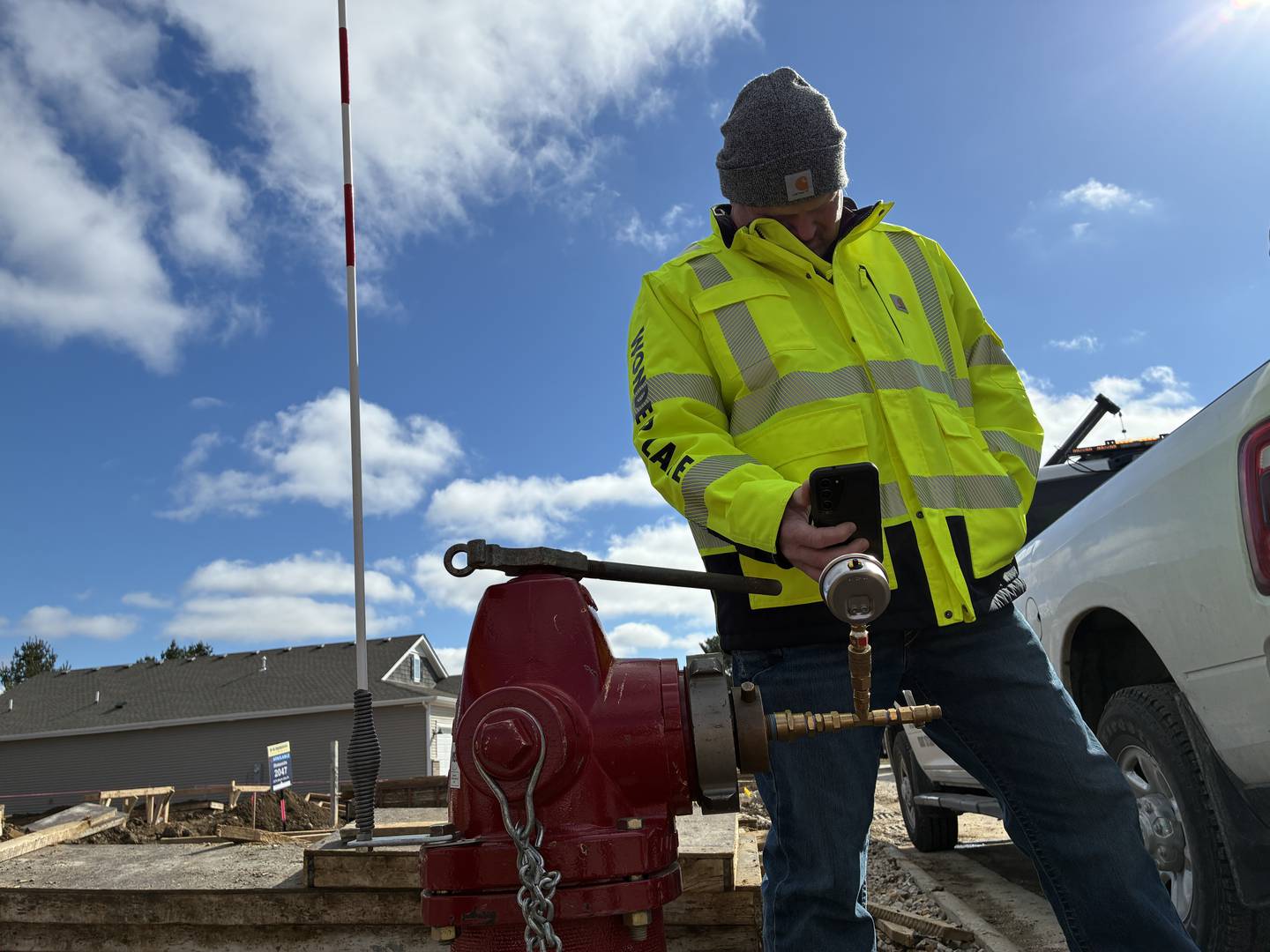 Wonder Lake Village President Dan Dycus records pressure readings on Friday, March 27, 2026, during a fire flow test of village hydrants.