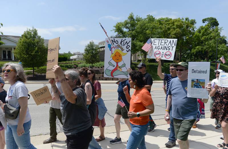 An estimated 1,200 people march from Elmhurst City Hall to Glos Memorial Park and back chanting "Hey Hey, Ho Ho, Donald Trump Has Got To Go" while participating in the nationwide No Kings Day Rally Saturday June 14, 2025.