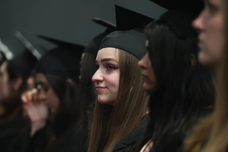 A graduate sits among her peers at the Joliet Junior College Commencement Ceremony on Friday, May 19, 2023, in Joliet.