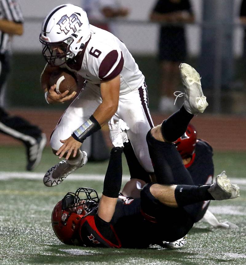 Prairie Ridge's Luke Vanderwiel runs through the tackle attempt of Huntley's Noah Van de Voorde during a Fox Valley Conference football game on Friday, Sept. 20, 2024, at Huntley High School.