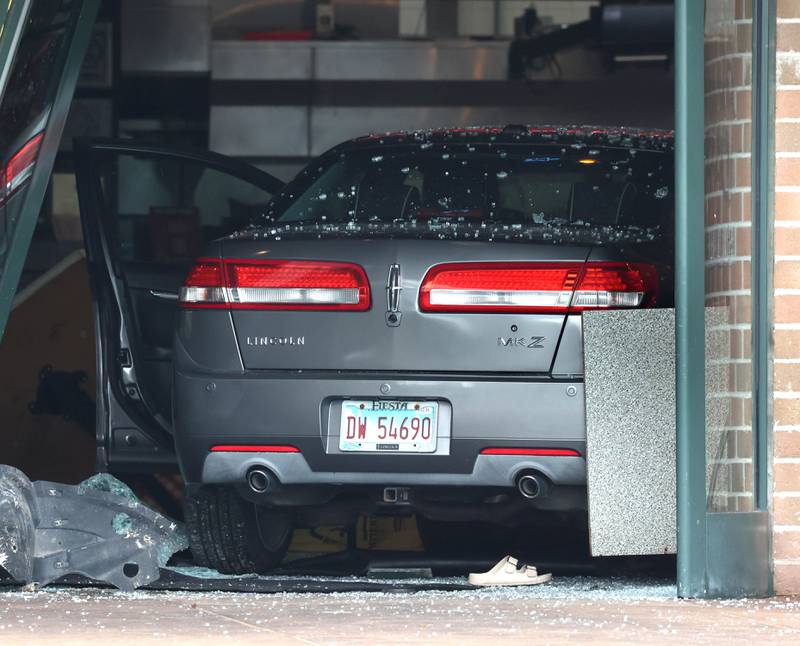 A car sits in the entrance to the Portillo’s Wednesday, July 30, 2025, after it crashed through the front entrance of the business at 2810 U.S. Route 34 in Oswego injuring 12.