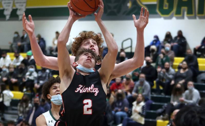 Huntley’s John Kramer, front, and Adam Guazzo go up for the ball in boys varsity basketball at Crystal Lake South Friday night.