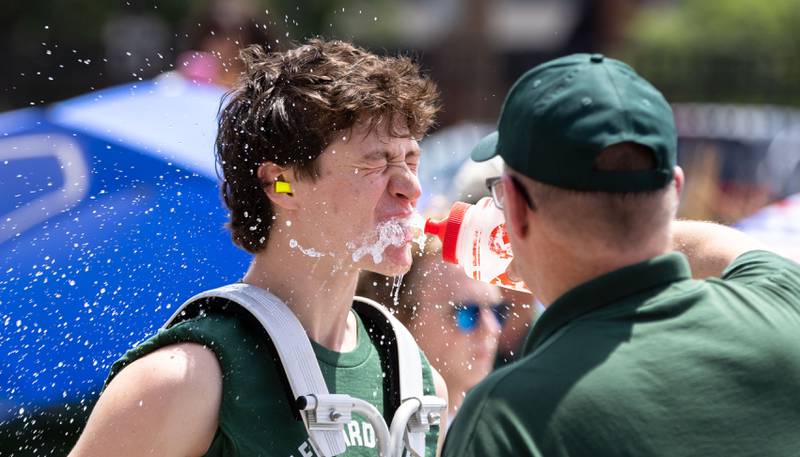 A Glenbard West drummer stays hydrated during Glen Ellyn’s “4th of July Parade” on Friday, July 4, 2025.
