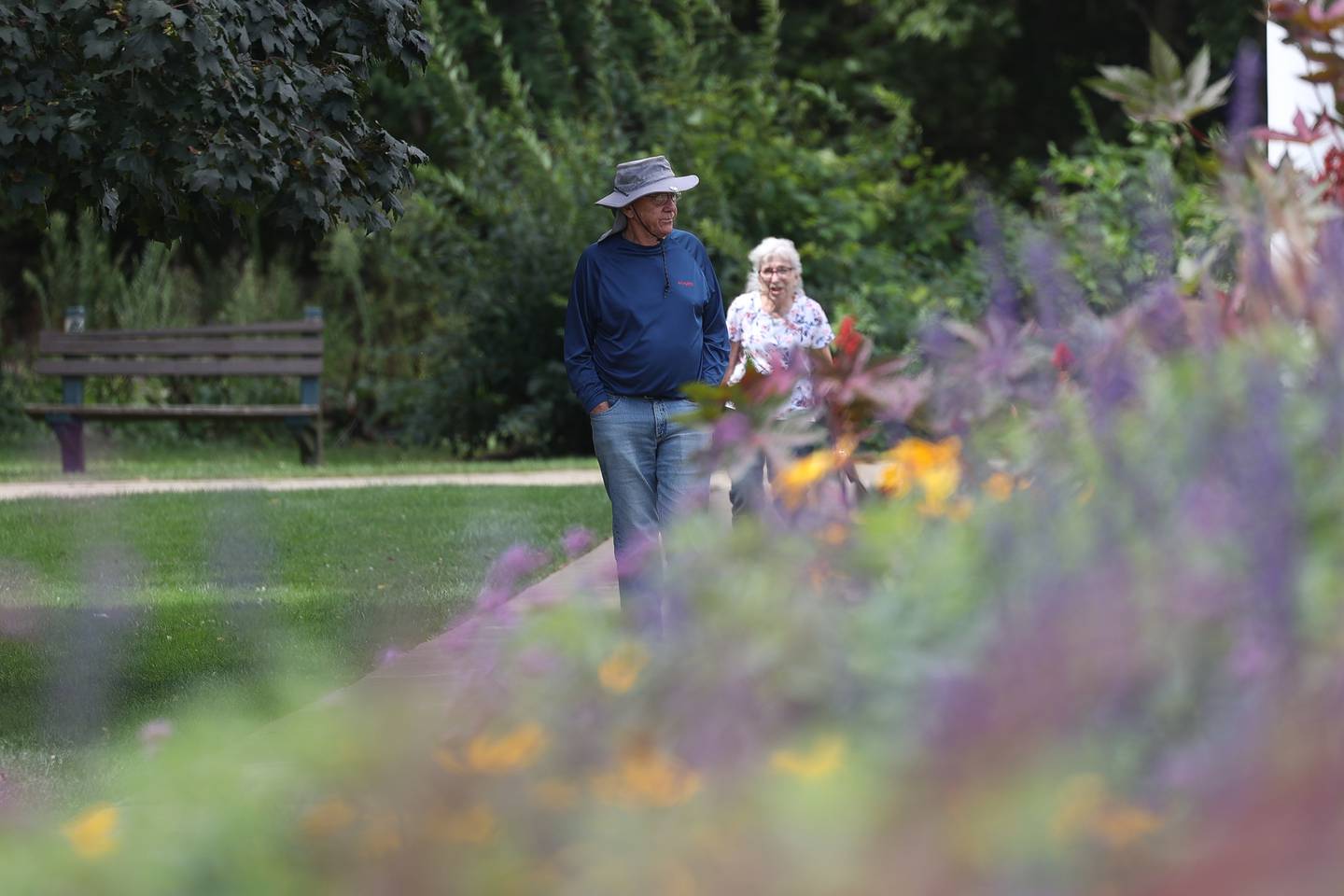 A couple walks along the greenhouse at the Bird Haven Greenhouse and Conservatory on Wednesday, Aug. 30, 2023 in Joliet.