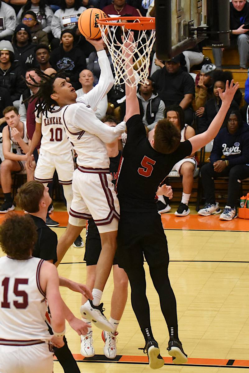 Kankakee's Lincoln Williams, left, takes a shot at the basket contested by Metamora's Matthew Zobrist during the IHSA Class 3A Washington Sectional semifinals Tuesday, March 4, 2025.