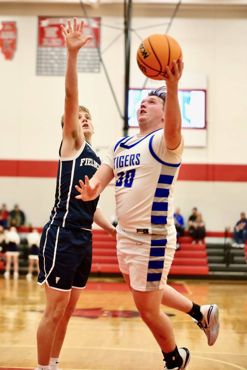 Princeton's Jordan Reinhardt drives for a layup against Fieldcrest Tuesday night at Hall High School.