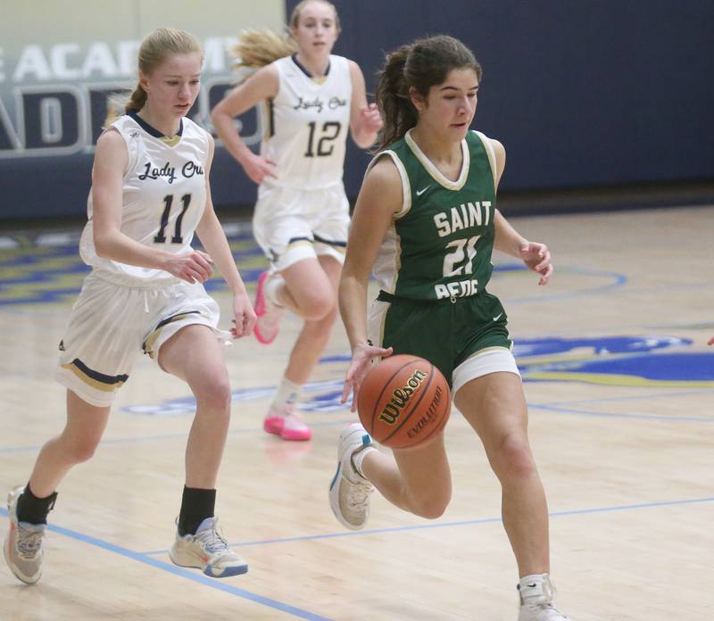 St. Bede's Lily Bosnich dribbles down the baseline as Marquette's Keely Nelson trails behind on Monday, Nov. 27, 2023 in Bader Gym at Marquette High School.