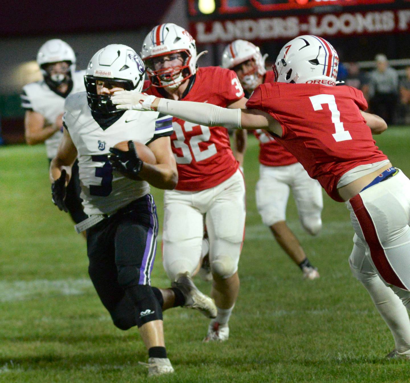 Dixon's Jake Zepezauer (3) runs past Oregon's Ethan Peeling (7) and Jakob Moser (32) en route for a touchdown in the opening minutes against Oregon on Friday, Sept. 26, 2025 at Landers-Loomis Field in Oregon.