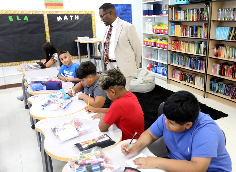 Harvard School District 50 Superintendent Brandon White visits with fifth grade students at Jefferson Elementary School during the first day of school on Wednesday, Aug. 13, 2025, in Harvard. White was previously was the superintendent of Cary School District 26.