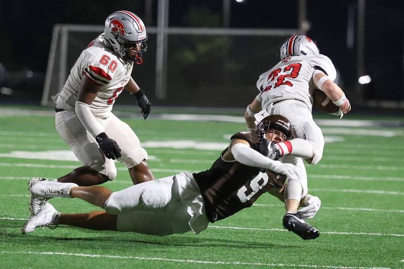 Joliet Catholic’s Zac Beitler brings down the runner against Iowa City on Friday, August 30, 2024 in Joliet.