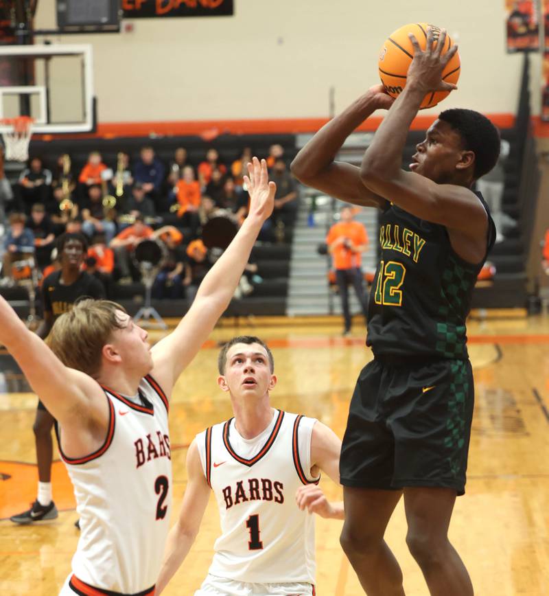 Waubonsie Valley's Tyreek Coleman shoots over DeKalb's Sean Reynolds during their game Friday, Feb. 21, 2025, at DeKalb High School.