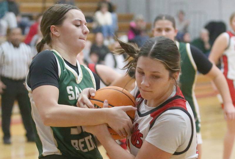 St. Bede's Quinn McClain and Henry-Senachwine's Kaitlyn Anderson tug at a jump ball on Thursday, Jan. 30, 2025 at Henry-Senachwine High School.