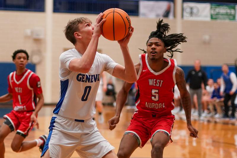 Geneva’s Dane Turner (0) shoots the ball in the post against West Aurora's Terrence Smith (5) during a MLK Day of Hoops basketball game at Geneva High School on Monday, Jan. 20, 2025.