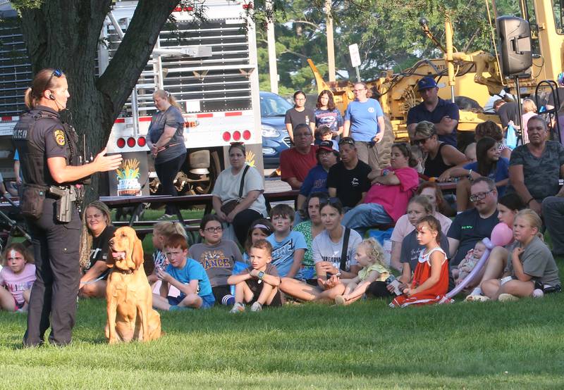 Princeton Police K-9 handler Sara Larkin, talks to kids about her partner Lucy, a certified Bloodhound trained in man trailing during the National Night Out event on Tuesday, Aug. 5, 2025 at Zearing Park in Princeton. The event featured K-9 and drone demonstrations, Mr. Cinnamon balloon twister, face painting, emergency vehicles, and more. National Night Out is an annual community policing campaign held on the first Tuesday of August to create police-community partnerships and build safer neighborhoods.