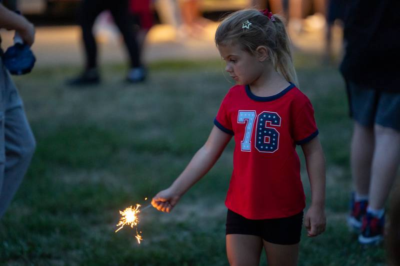 Judith Torbik holds sparkler on Saturday, July 5, 2025 at Carey Memorial Park in Utica.