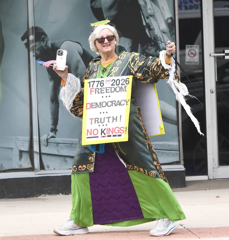 A woman demonstrating at the No Kings rally on Saturday, Oct. 18, 2025 on the Ogle County Courthouse Square, films the crowd from across state Route 64 in downtown Oregon, Illinois.