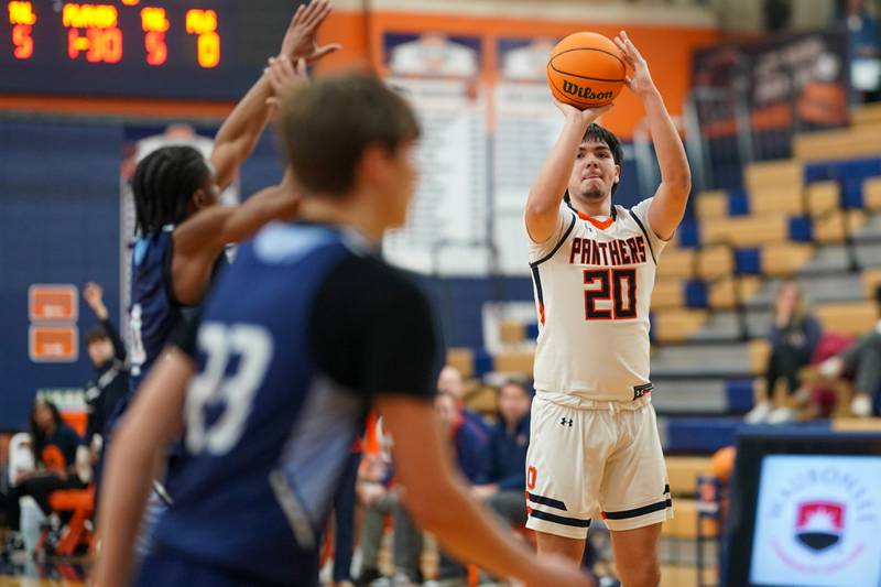 Oswego’s Michael Delgado (20) shoots a three pointer against Plainfield South's Brilan Townsend (4) during a basketball game at Oswego High School on Friday, January 17, 2025.