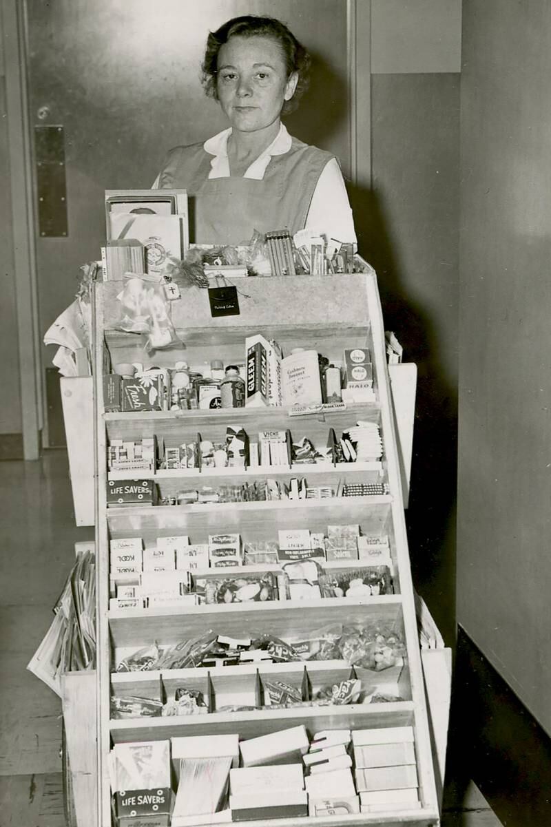 A CGH Auxiliary volunteer delivers amenities to hospital patients in the 1950s.