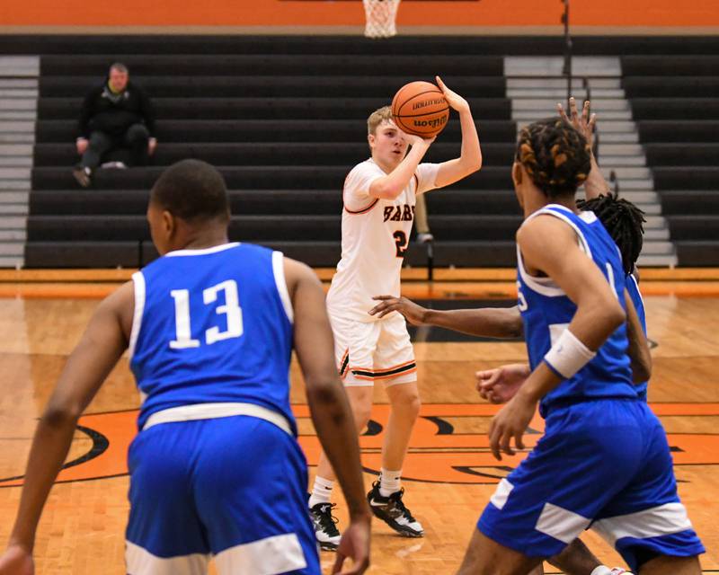 DeKalb Sean Reynolds (2) takes a shot in the second quarter over Phillips defenders on Friday Dec. 30th during The Chuck Dayton Classic Tournament held at DeKalb High School.