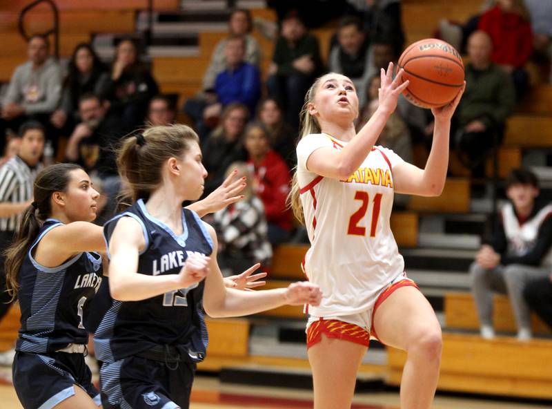 Batavia’s Kylee Gehrt (21) gets a shot up during a home game against Lake Park on Tuesday, Dec. 6, 2022.