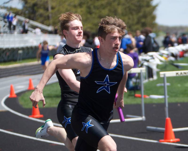St. Charles North's Wylder Smith hands of to Austin Fraser in the 4 X 200 Relay at Kaneland's Peterson Prep invite on Saturday, April 26,2025 in Maple Park.