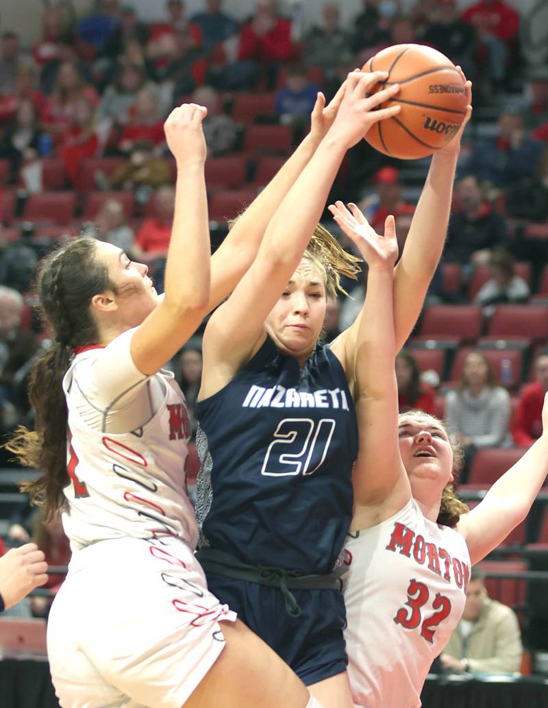 Nazareth's Olvia Austin grabs a rebound between two Morton defenders during their Class 3A state semifinal game Friday, March 4, 2022, in Redbird Arena at Illinois State University in Normal.