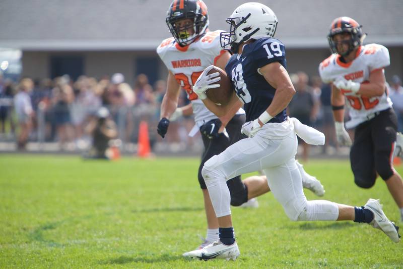 Cary-Grove's Andrew Prio with the carry as McHenry's Conner McLean looks for the tackle on Saturday, Sept. 17,2022 in Cary.
