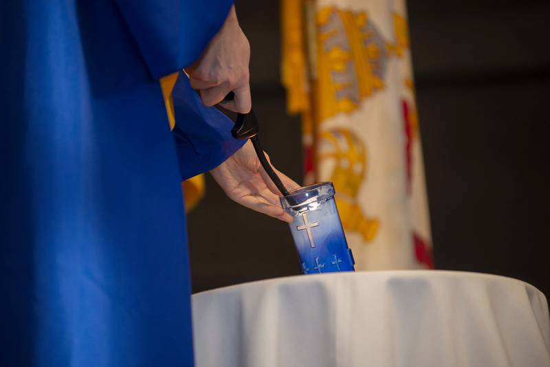 Salutatorian Alicia Ardis lights a candles it recognition of her respect life prayer Wednesday, May 18, 2022.