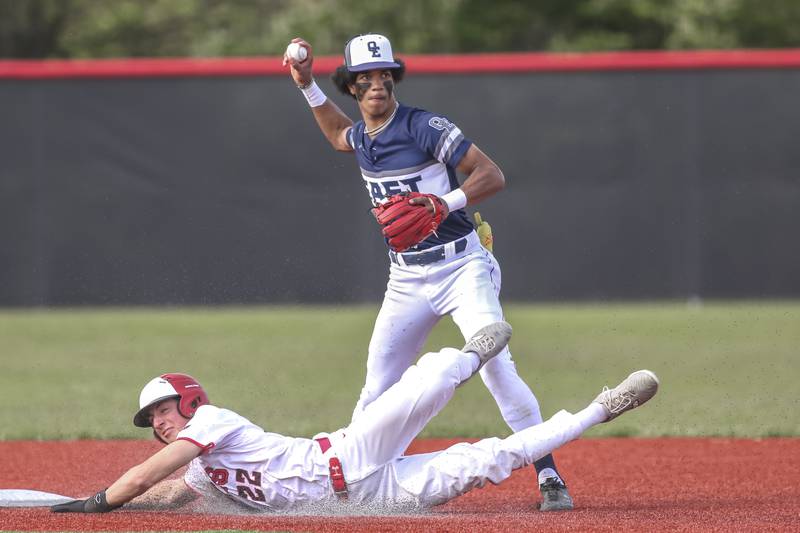 Oswego East's Jacsen Tucker (17) throws to first to complete a double play during baseball game between Oswego East at Yorkville. Monday, May 12, 2025 in Yorkville.