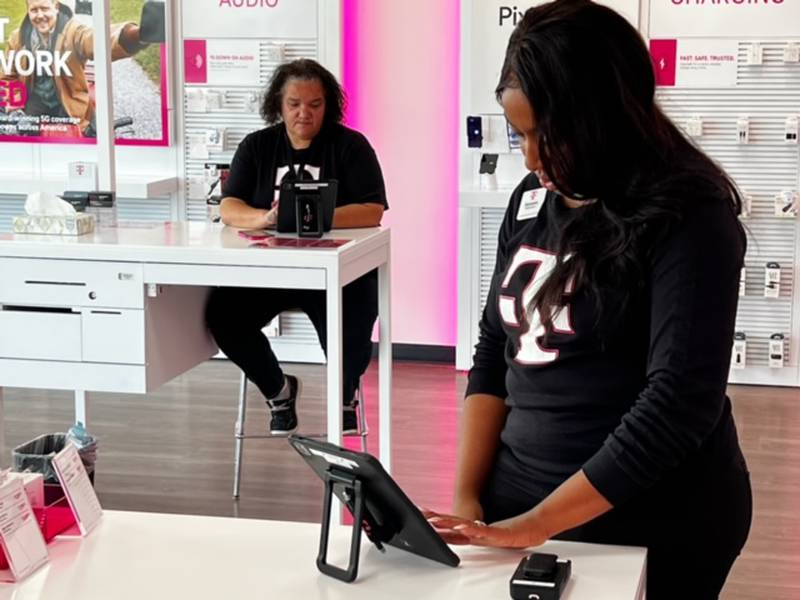 Mobile expert Luciana Hannan (left) and
mobile expert Senovia Grier are shown at T-Mobile in Dixon.