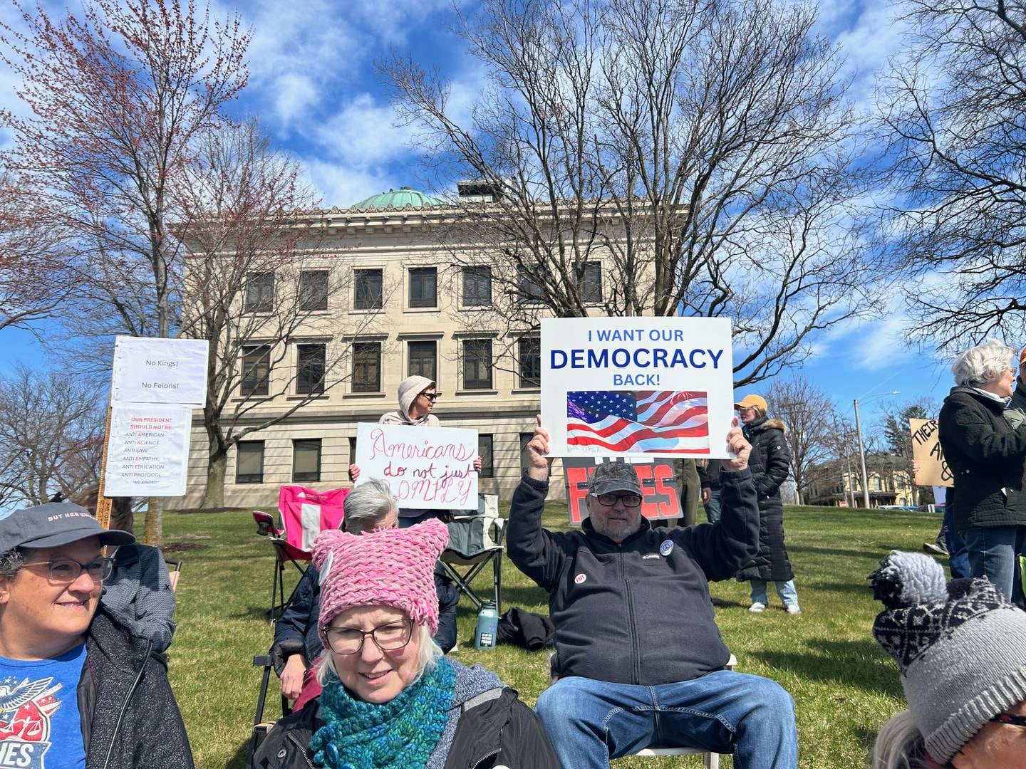 Protestors stood along Galena Avenue and sat in chairs on the Old Lee County Courthouse lawn on Saturday during a No Kings protest in Dixon.