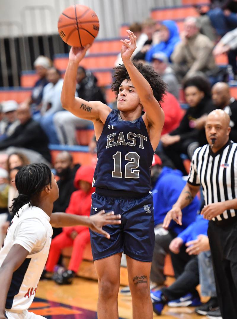 Oswego East's Drey Wisdom (12) shoots a three pointer during a Hoops for Healing tournament game against West Aurora on Nov. 20, 2023 at Naperville North High School in Naperville.