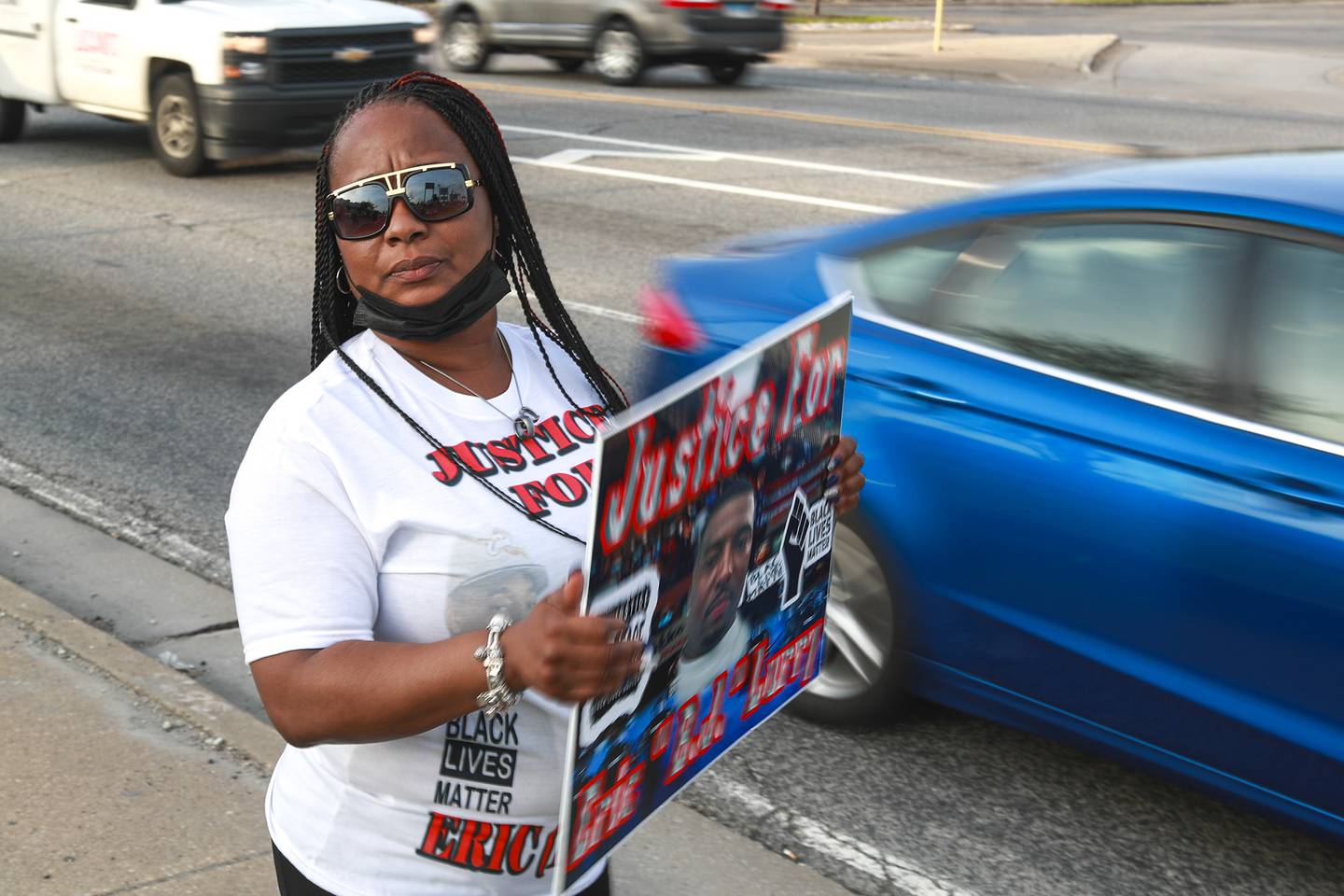 Nicole Lurry, widow of Eric Lurry, the Joliet man who died of an overdose in police custody, holds a sign calling for justice on Tuesday, April 27, 2021, at the corner of Larkin Ave. and Jefferson st. in Joliet, Ill.