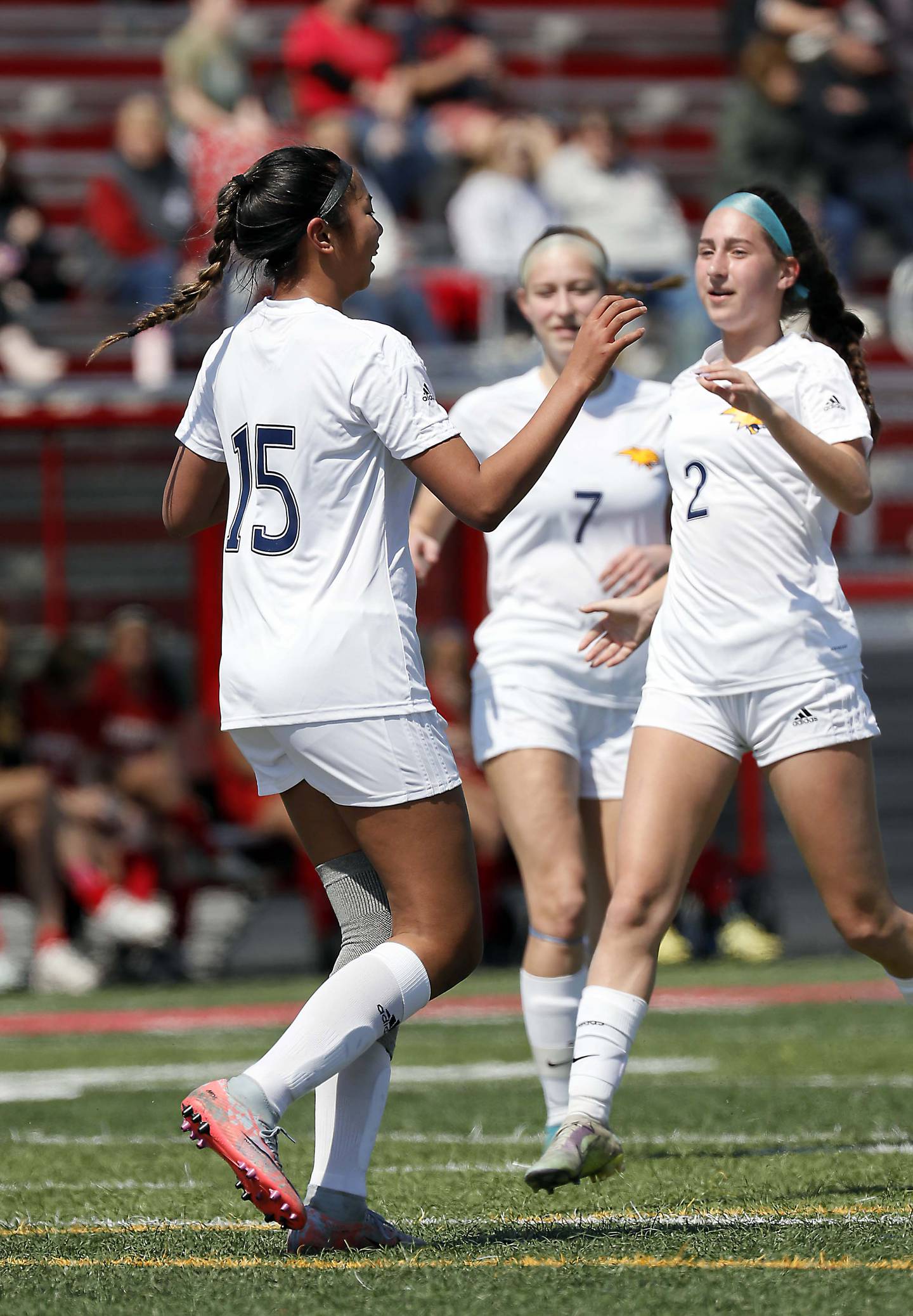 Neuqua Valley's Safa Jeffery (15) celebrates with her teammates after scoring Saturday April 8, 2023 in Batavia.