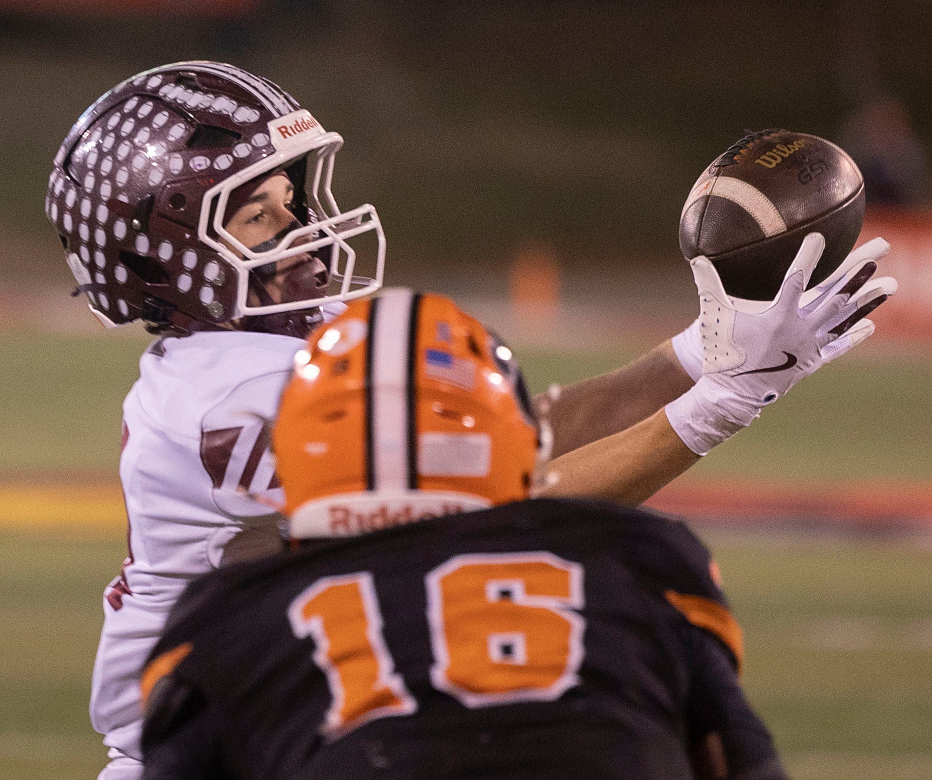 Tolono-Unity's Tyler Henry hauls in a pass in front of Byron’s Andrew Talbert Friday, Nov. 28, 2025, in the Class 3A football finals at Hancock Stadium at ISU.