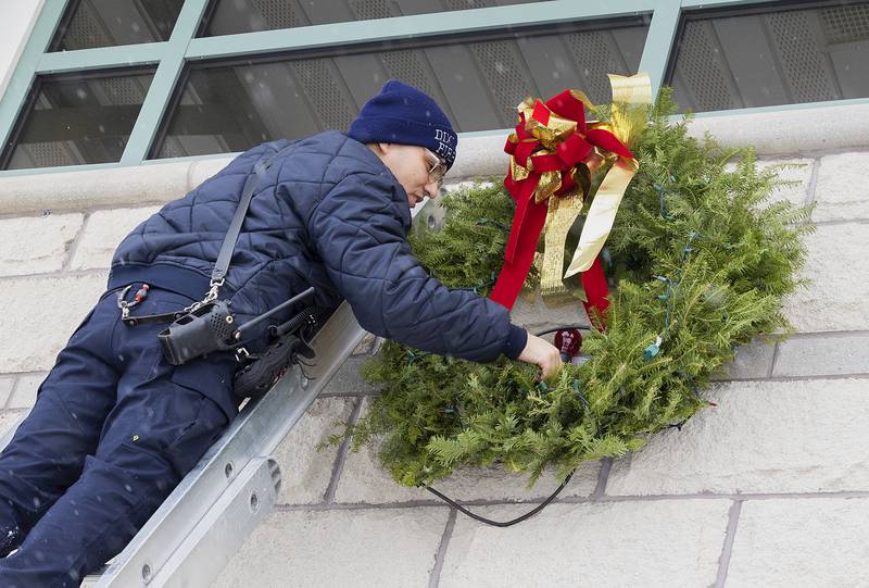Dixon firefighter Tristan Ramirez plugs in the wreath outside of the city department Monday, Dec. 2, 2024. Both city and rural stations have the wreaths on display.